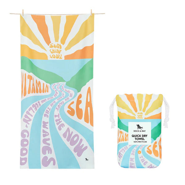 image showing vitamin sea design in pastel colours on the towel and the carry pouch it comes in