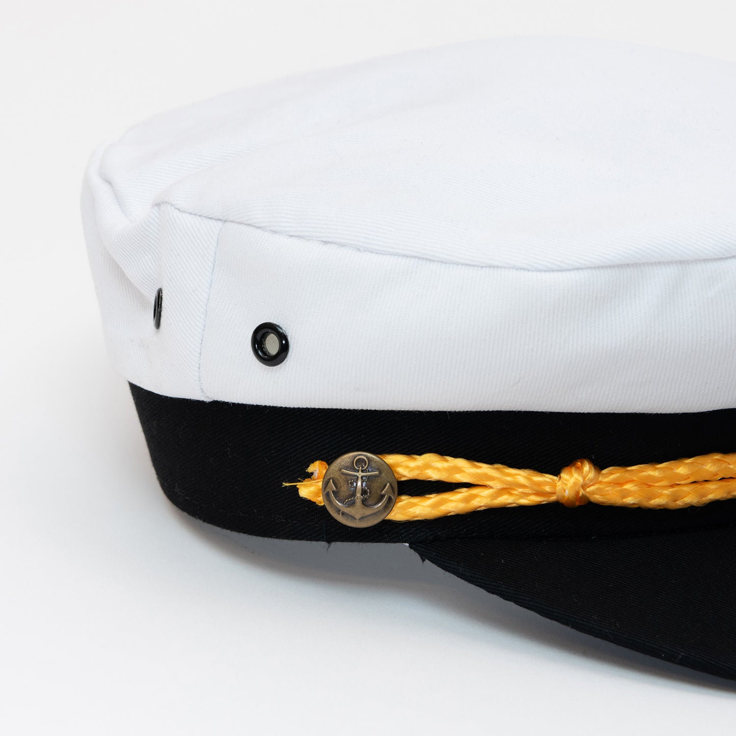 Close up of captain's hat anchor button detail, yellow braiding,
