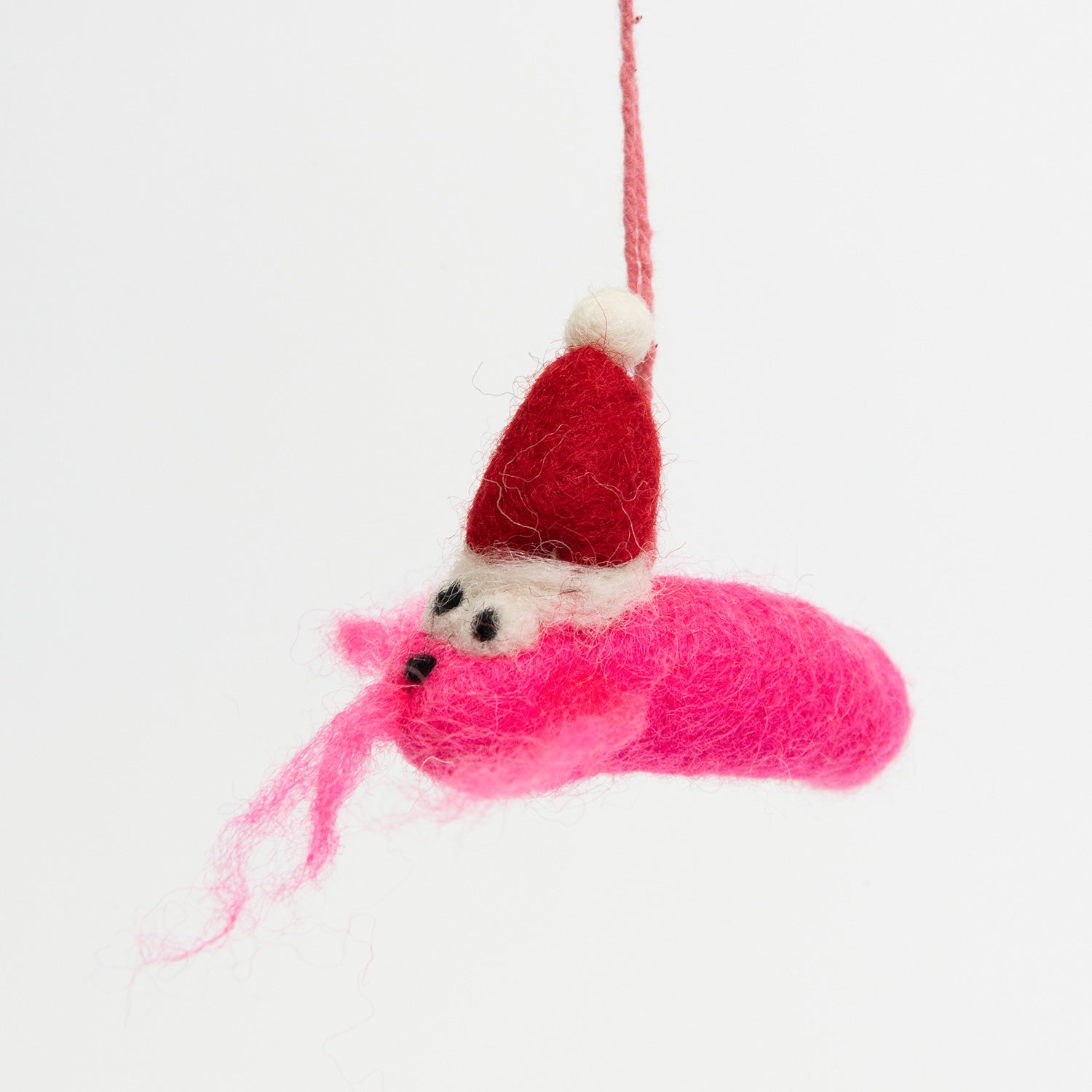 A Christmas decoration hanging on a metal rod on a white background. The decoration is a festive pink prawn wearing a Christmas hat.