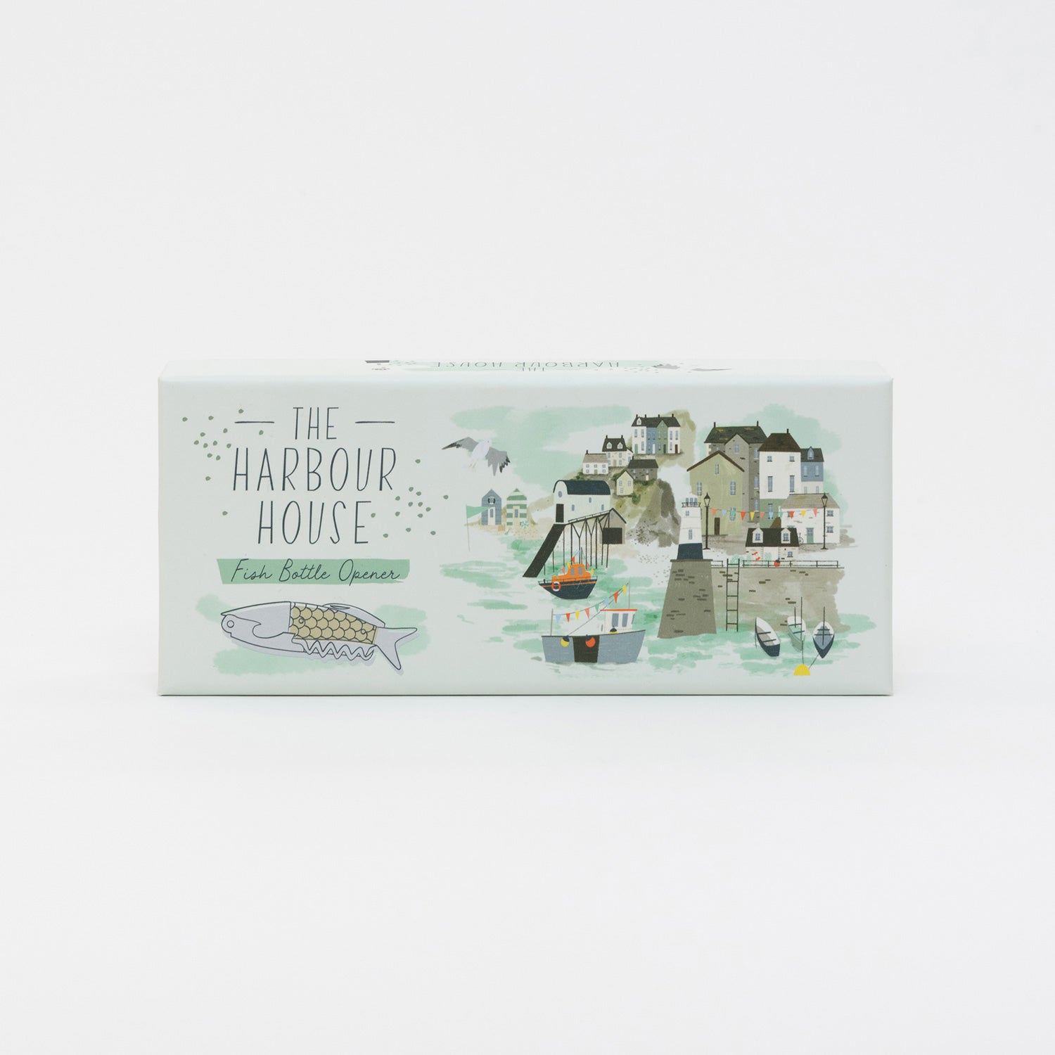 Top view of the box for the fish bottle opener featuring an illustration of the bottle opener and a seaside town and harbour.