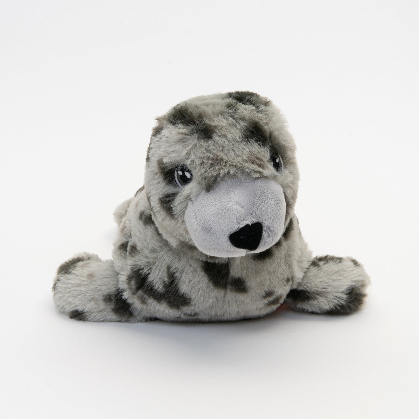 close up of eye and nose of light and dark grey spotted plush seal