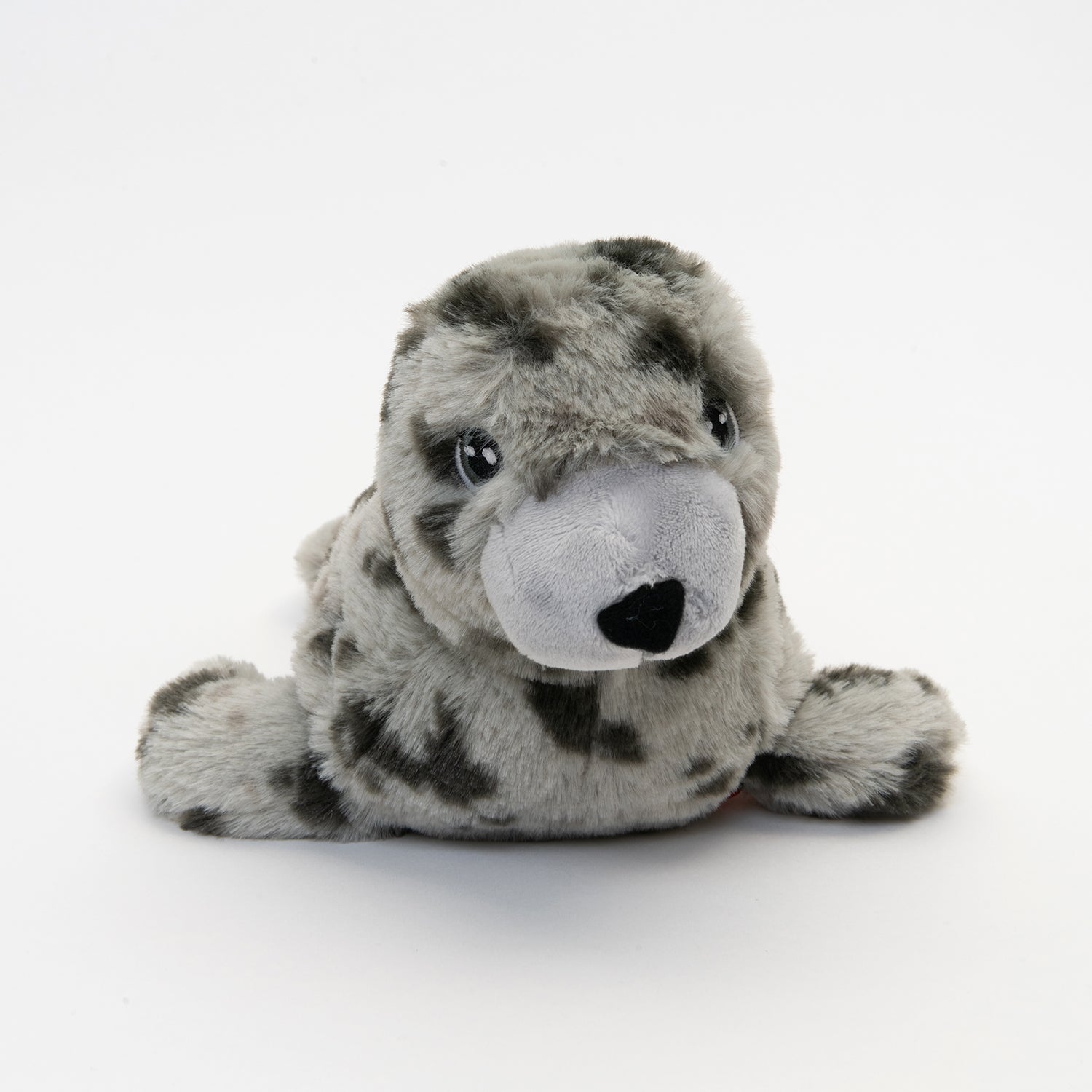 close up of eye and nose of light and dark grey spotted plush seal