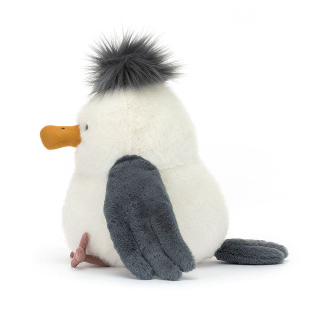 Plush toy seagull with a white body, grey wings, and an orange beak on a white background