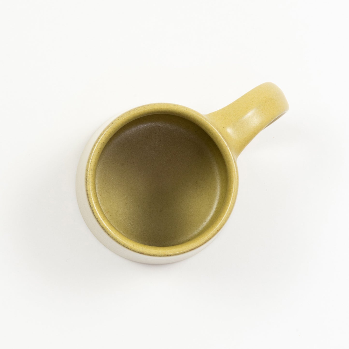 A mustard-yellow stoneware mug pictured on a white background.