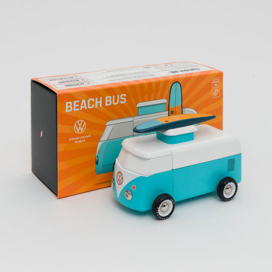 Shot of turquoise and white VW camper van with a wooden surfboard on the roof. Shot in front of its box