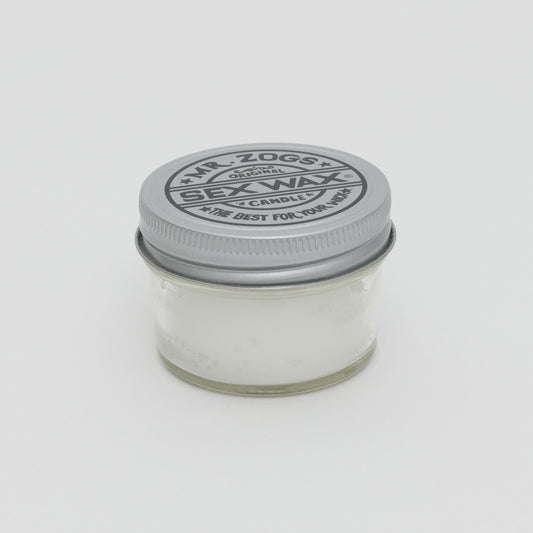 White candle in glass jar with screw lid