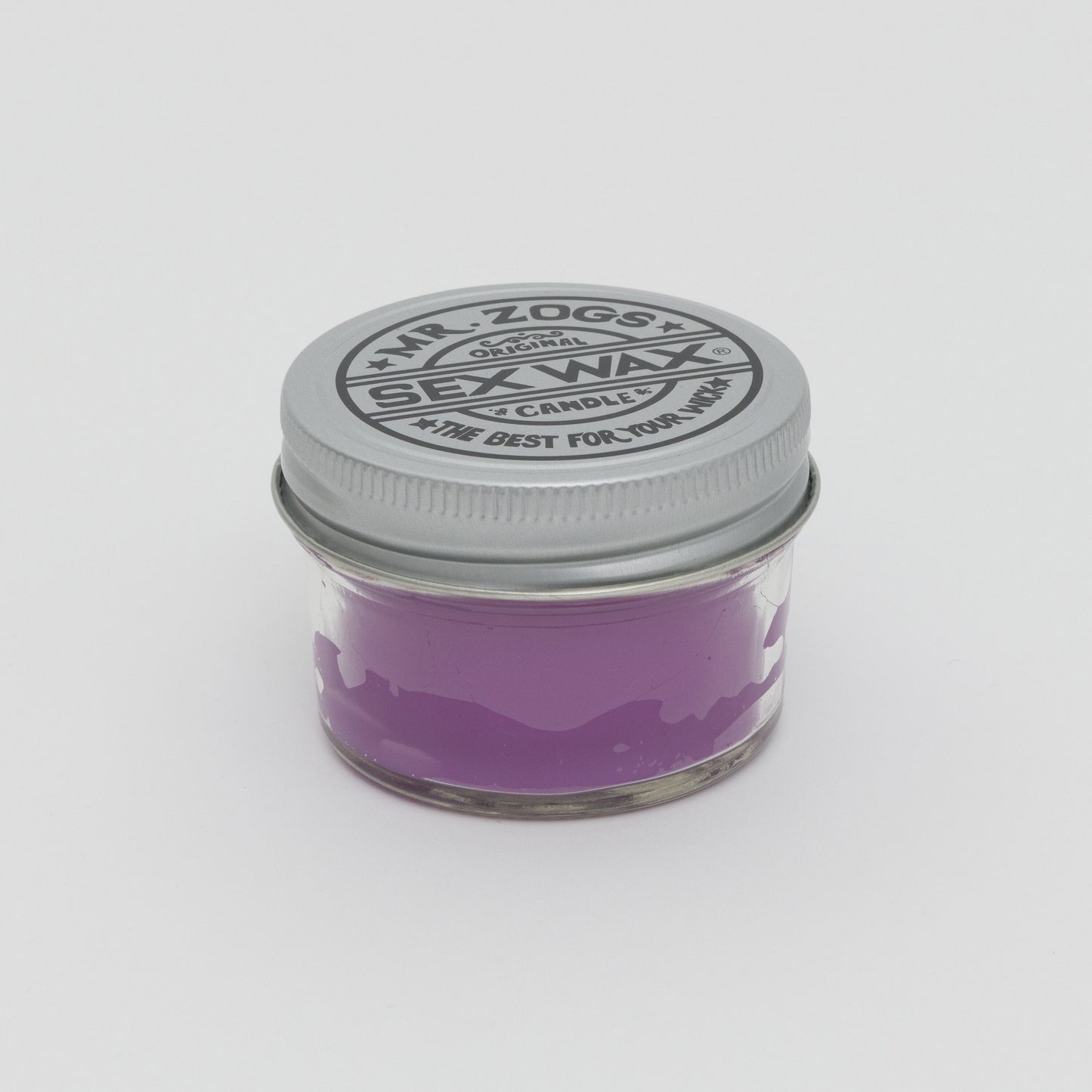 Purple candle in glass jar with screw lid