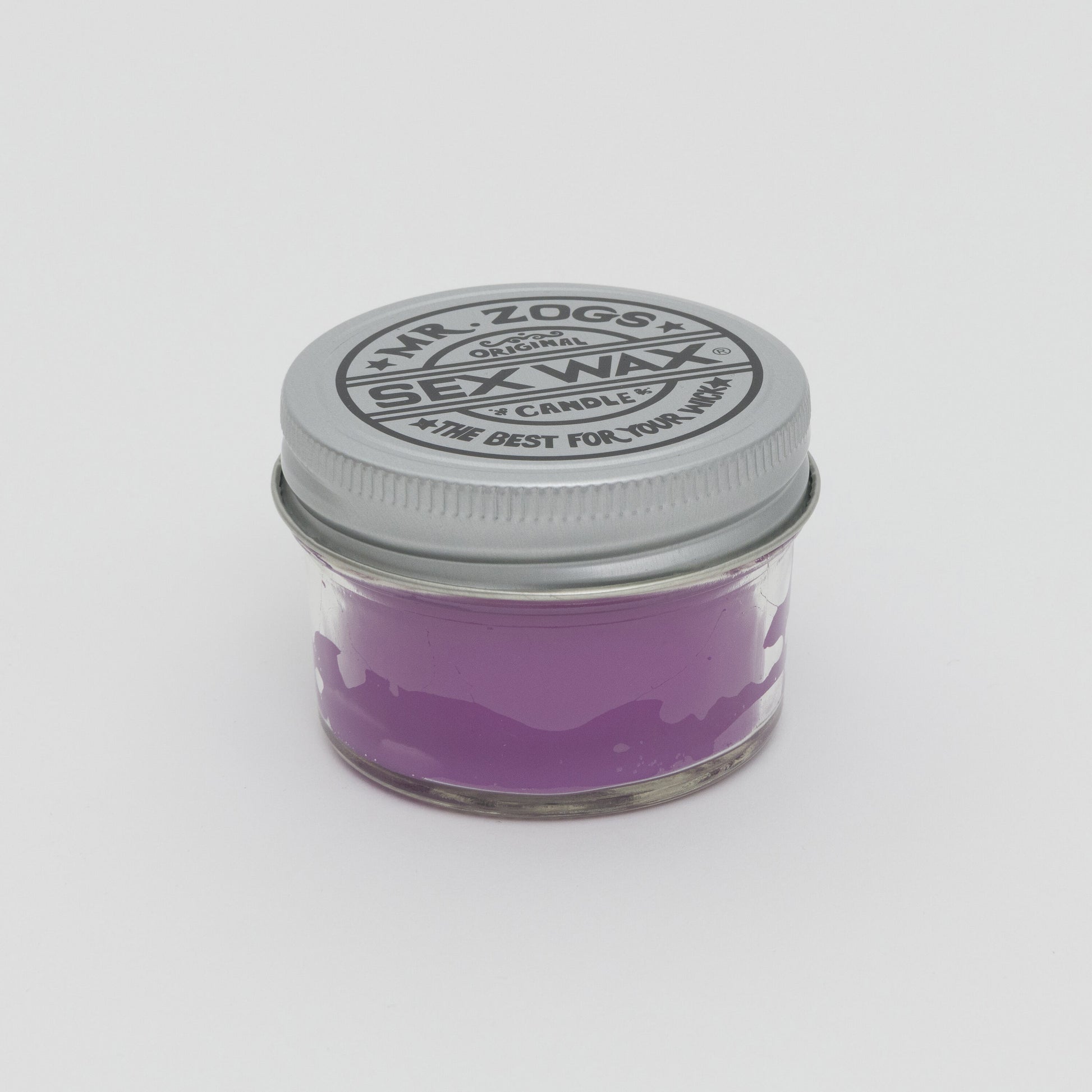 Purple candle in glass jar with screw lid