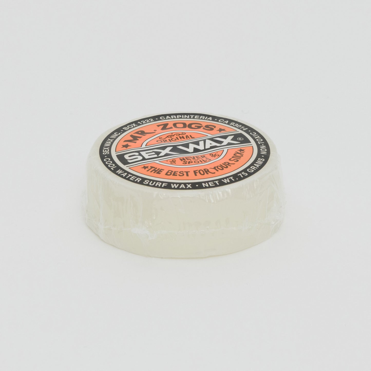 Image shows a clear disc of surfboard wax with orange Sex Wax branding