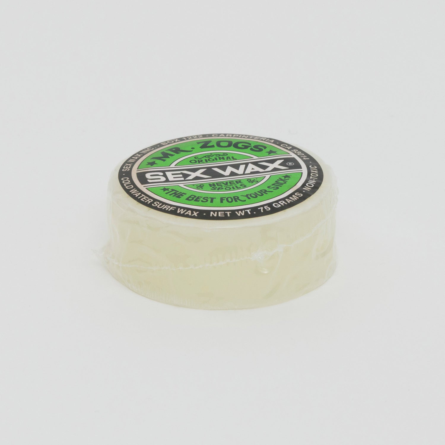 Image shows a clear disc of surfboard wax with green Sex Wax branding