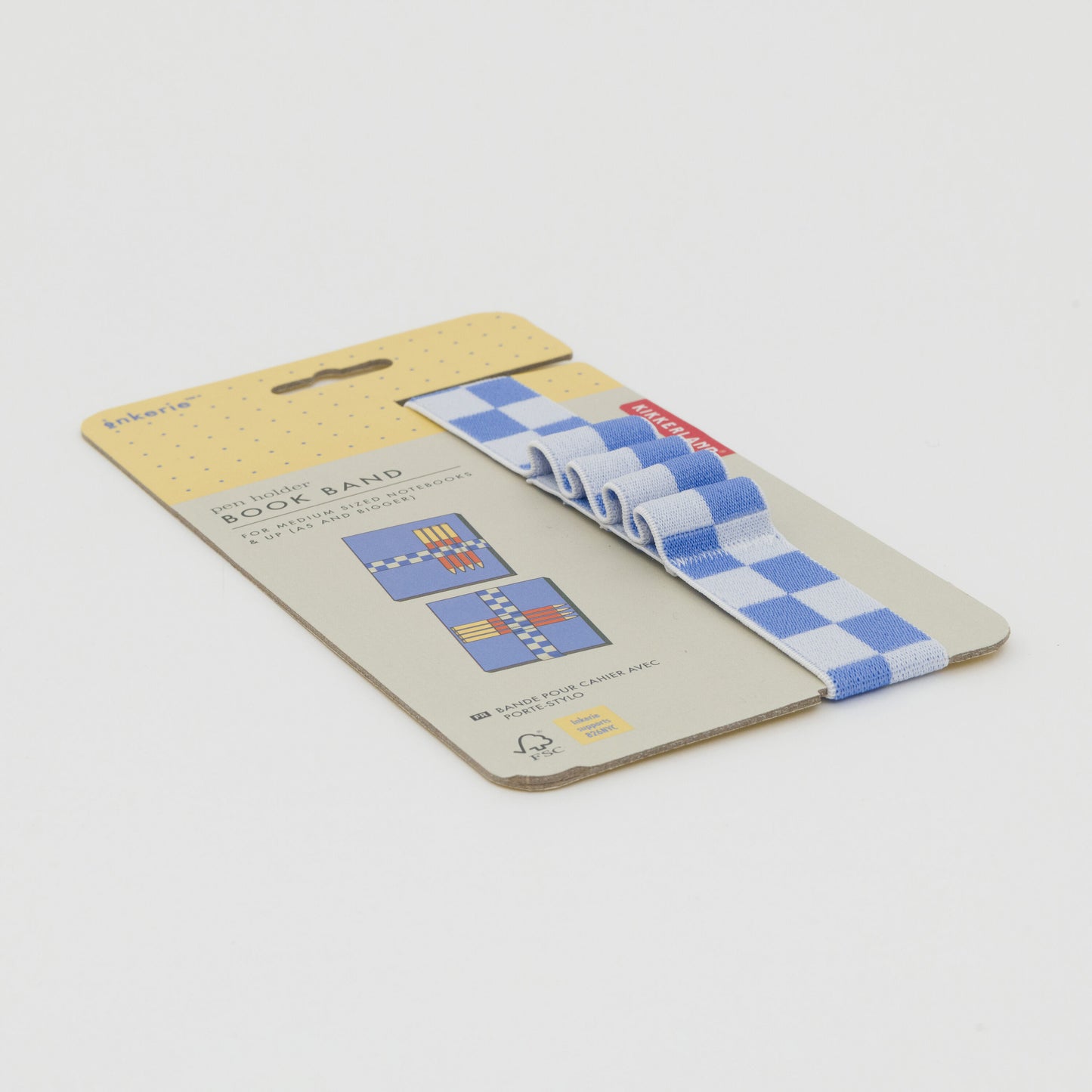 Three quarter length shot of blue and white checkerboard book band that holds 4 pens, displayed on its packaging.