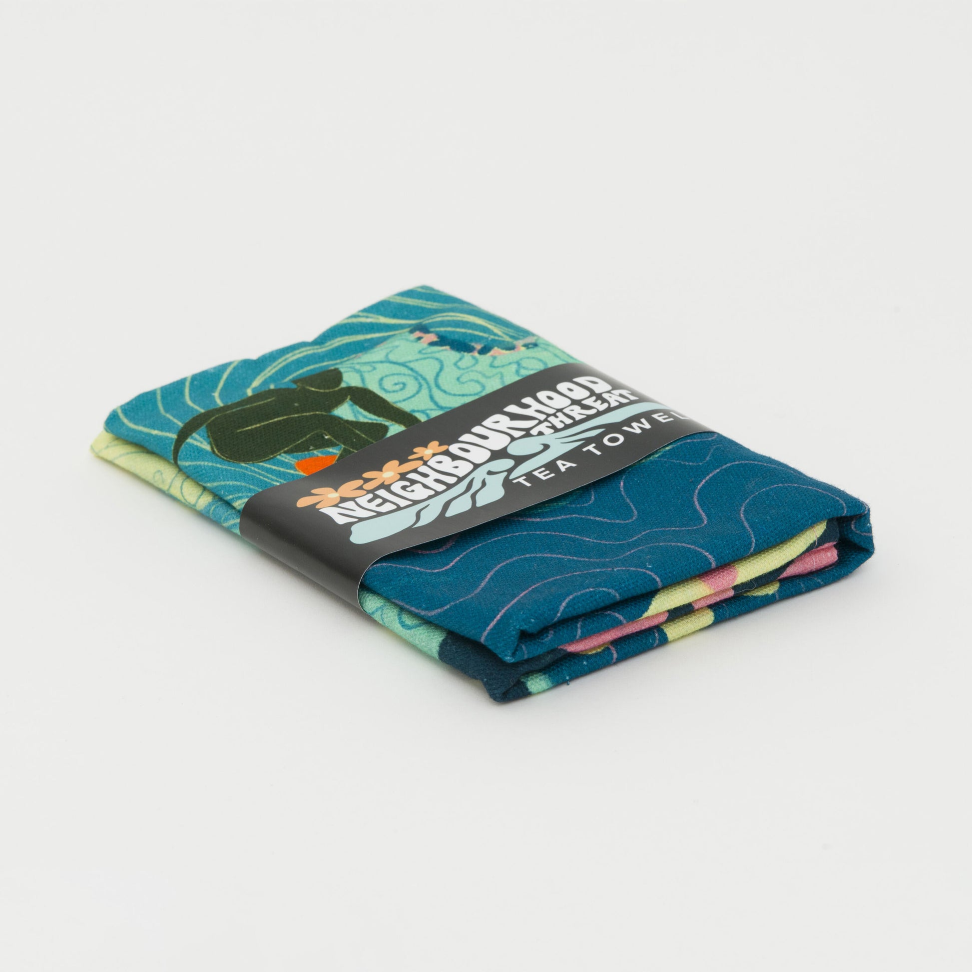 Tea towel folded up in its bellyband paper packaging