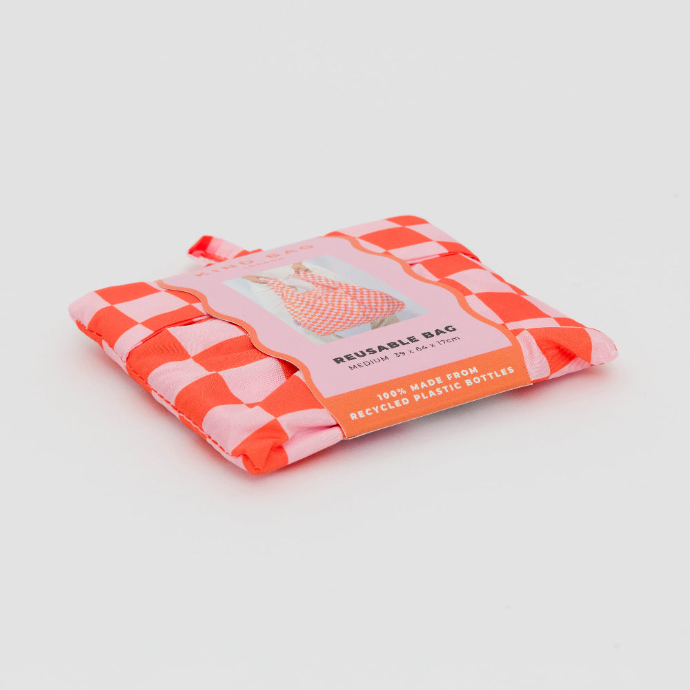 Close up of the pink and orange checkerboard bag folded up in its packaging