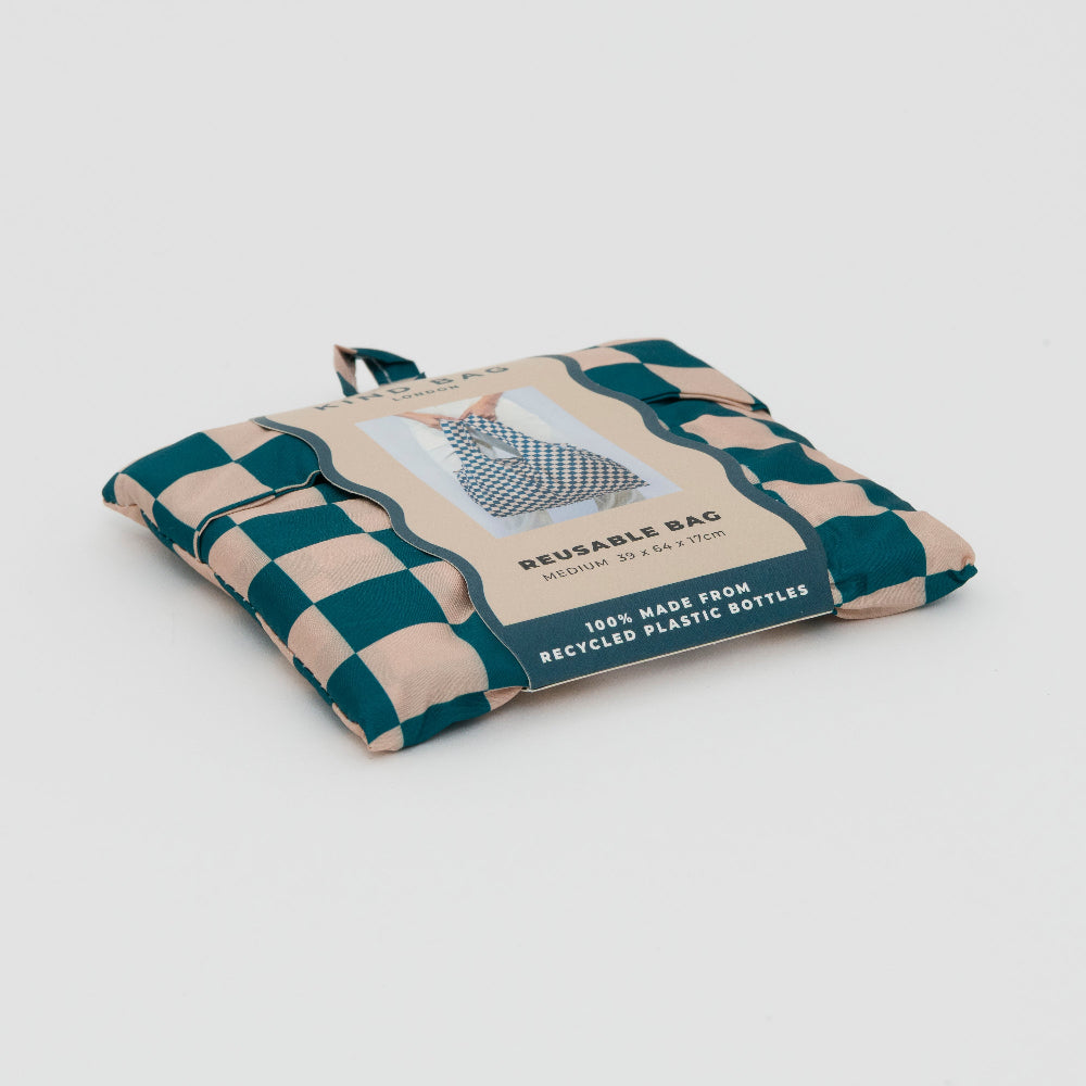 Shot of the checkerboard design bag in teal and beige folded up in its packaging.