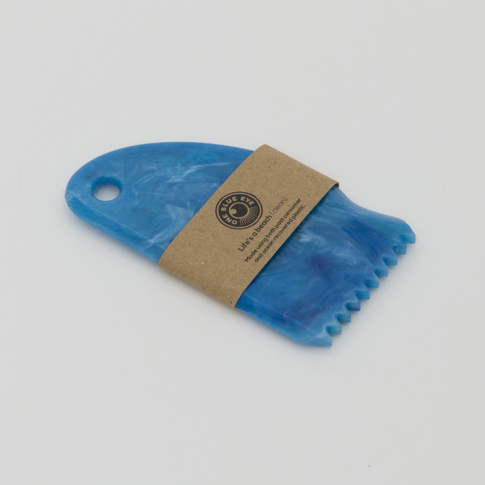 Three quarter image of blue recycled plastic surf wax comb