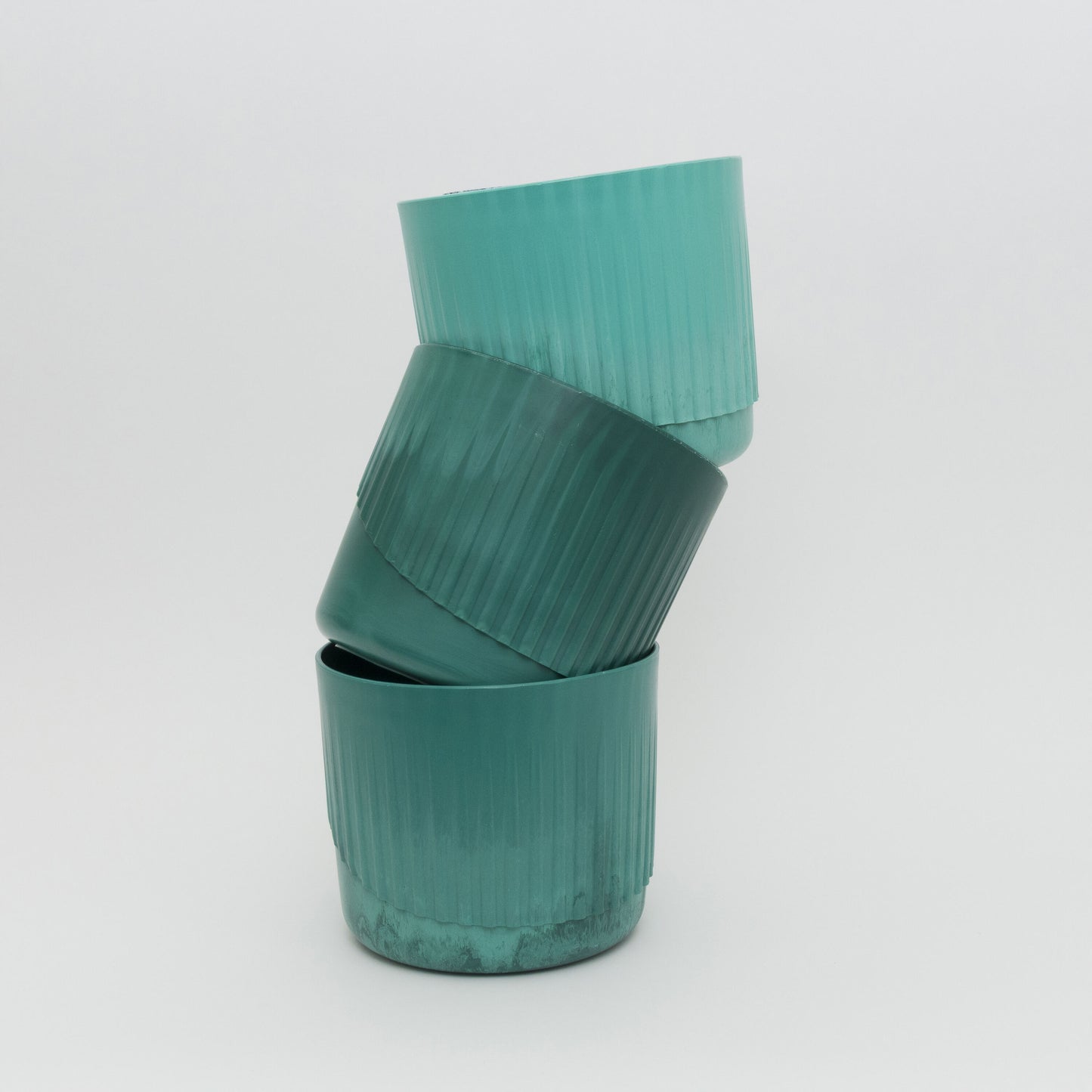 3 plant pots stacked showing colour variations in the green.
