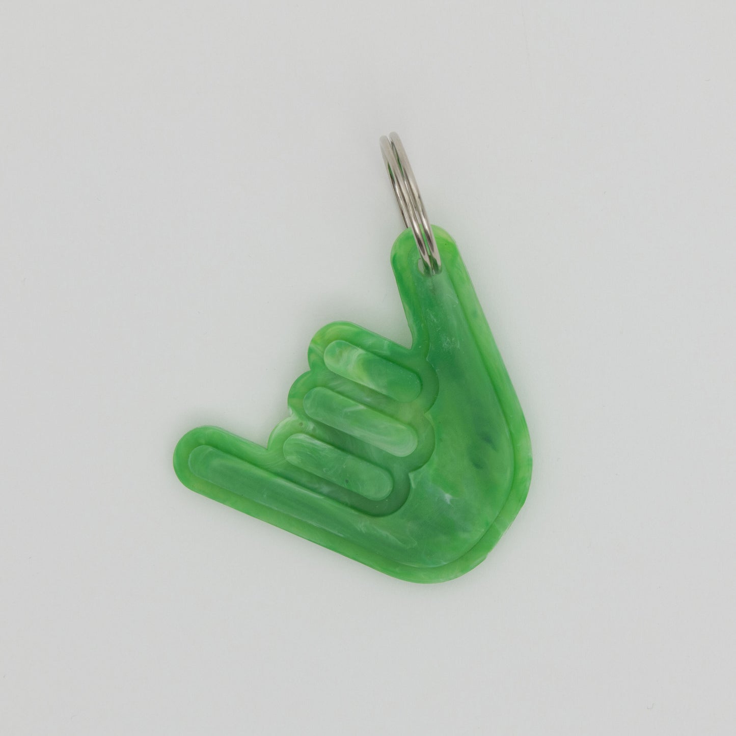 Green keyring of a had making a shacka sign