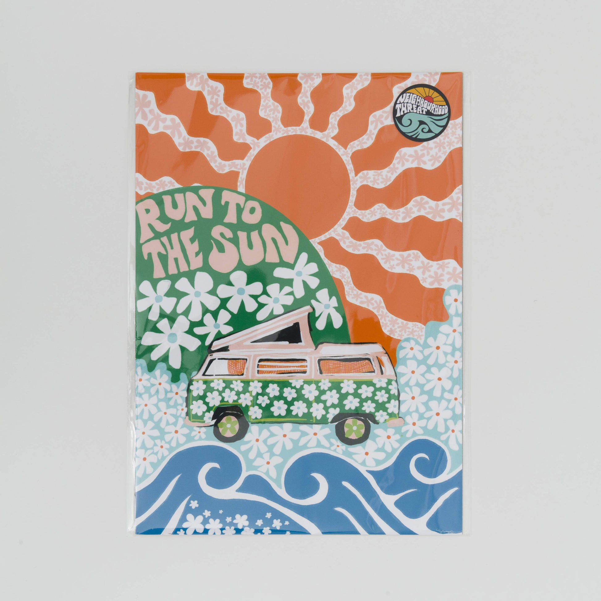 A4 print showing a green camper van covered in white daisies with a green hill in the background with daisies and the wording Run to the Sun in pink font. Big orange sun in the background.