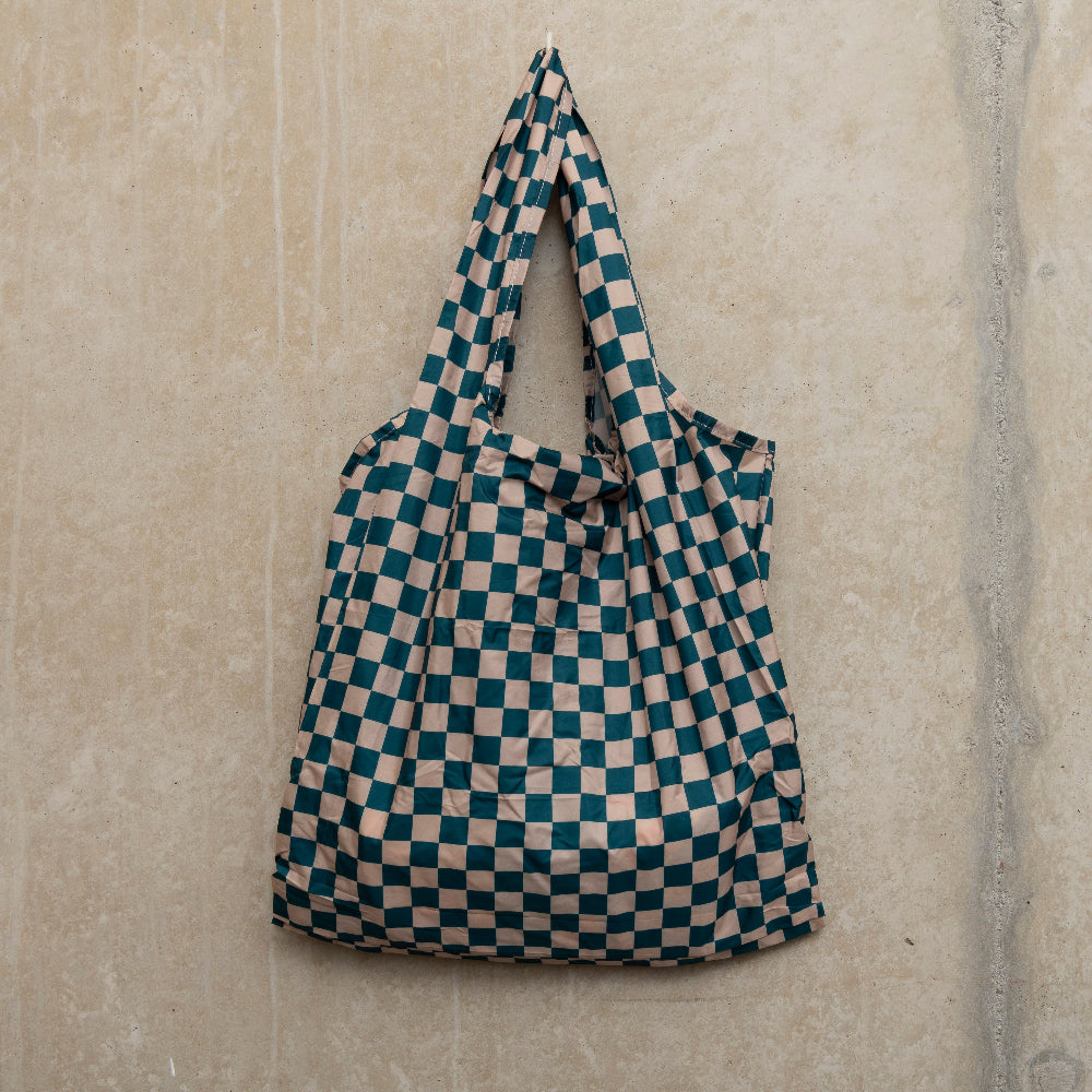 Image of checkerboard design bag in teal and beige, hanging on a hook