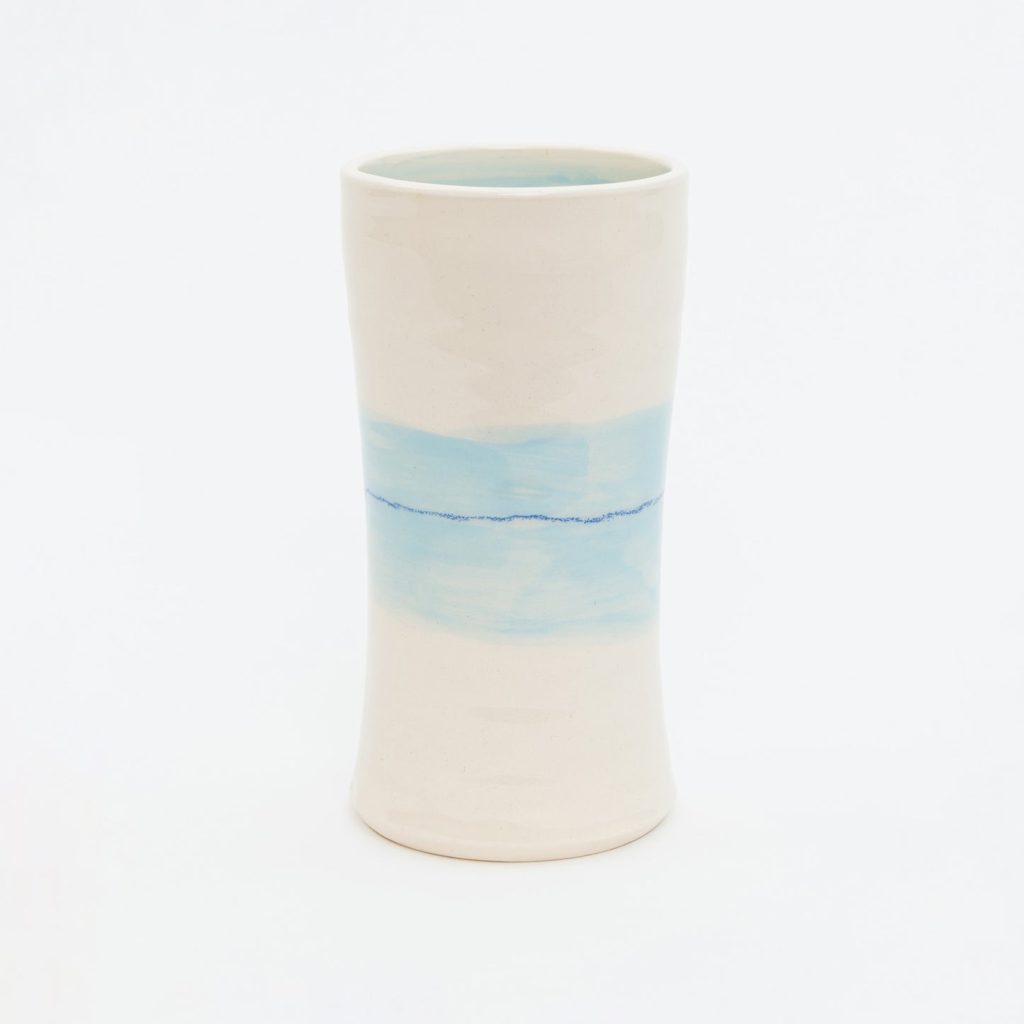 Ceramic vase with a gradient design from white to blue on a white background.