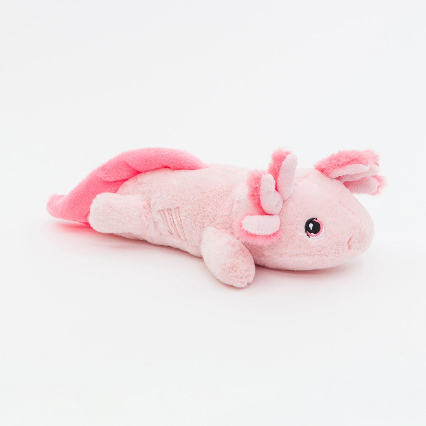 Pink plush axolotl toy on a white background