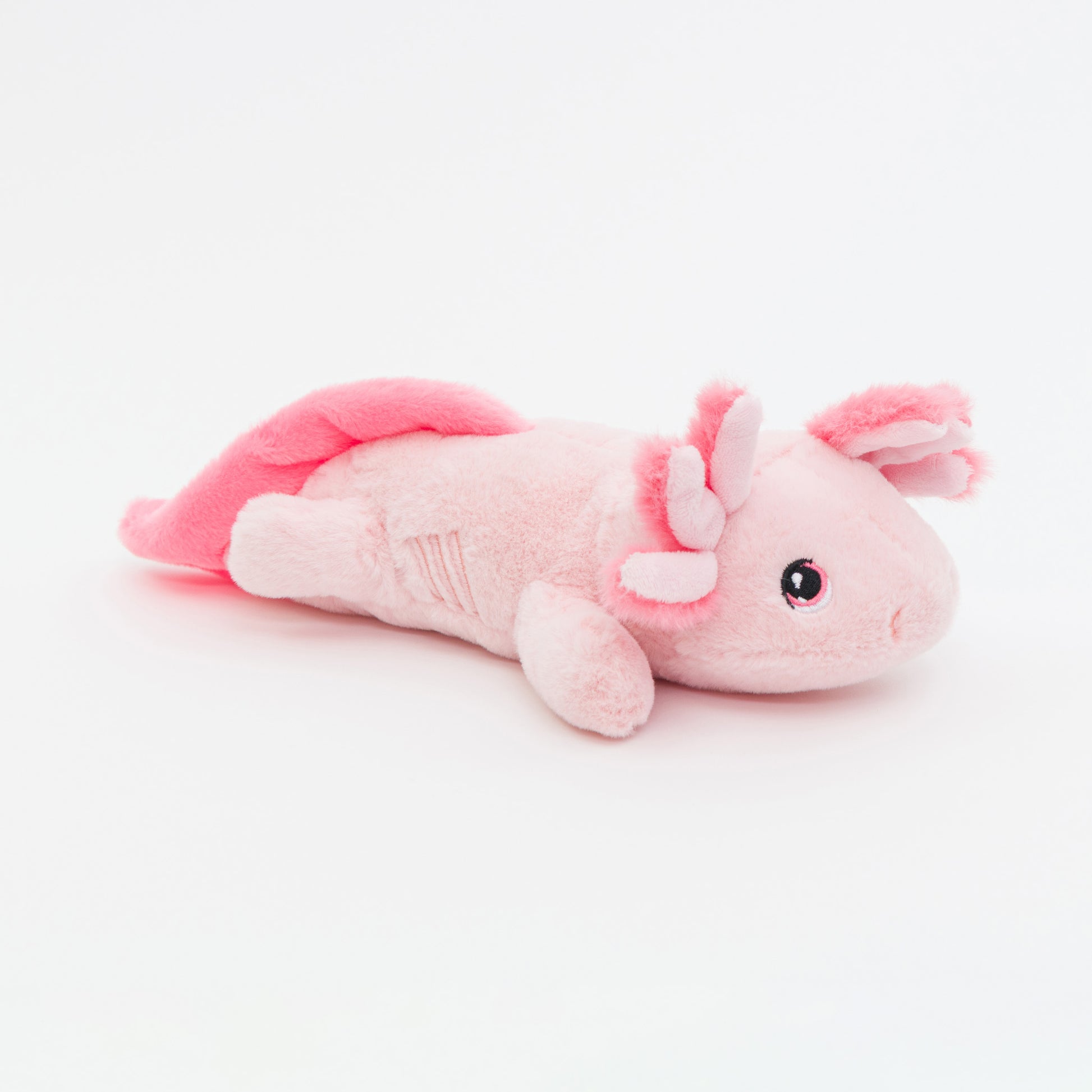 Pink plush axolotl toy on a white background