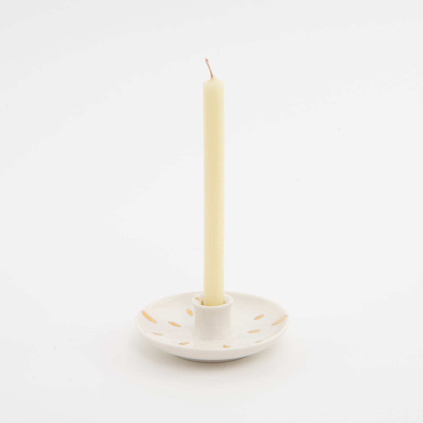 white ceramic candle holder with cream candle