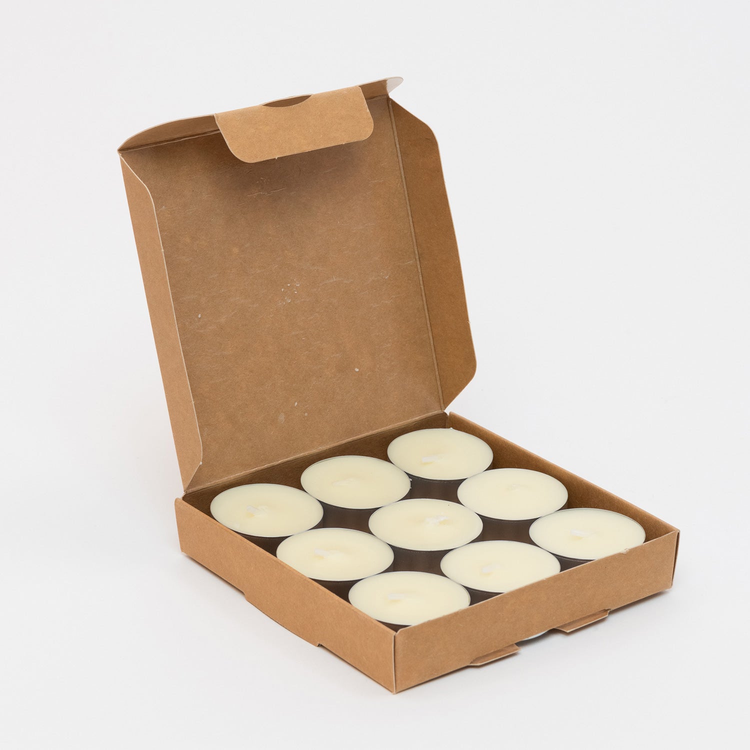 St Eval Sea Salt Tea Lights box of 9 candles. Plain earthy card box open to show 9 circle cream tealights.
