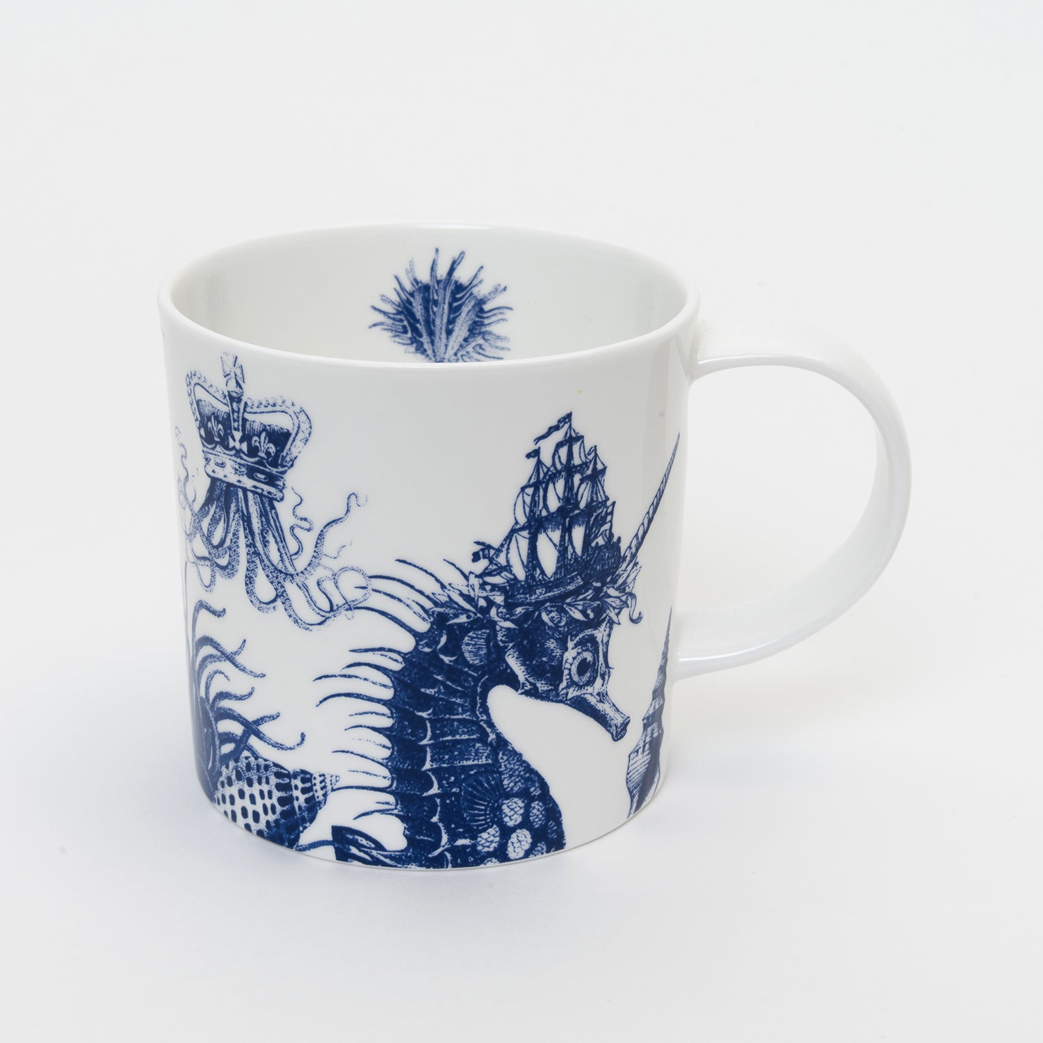 White mug with blue illustration of a seahorse wearing a tall ship as a crown