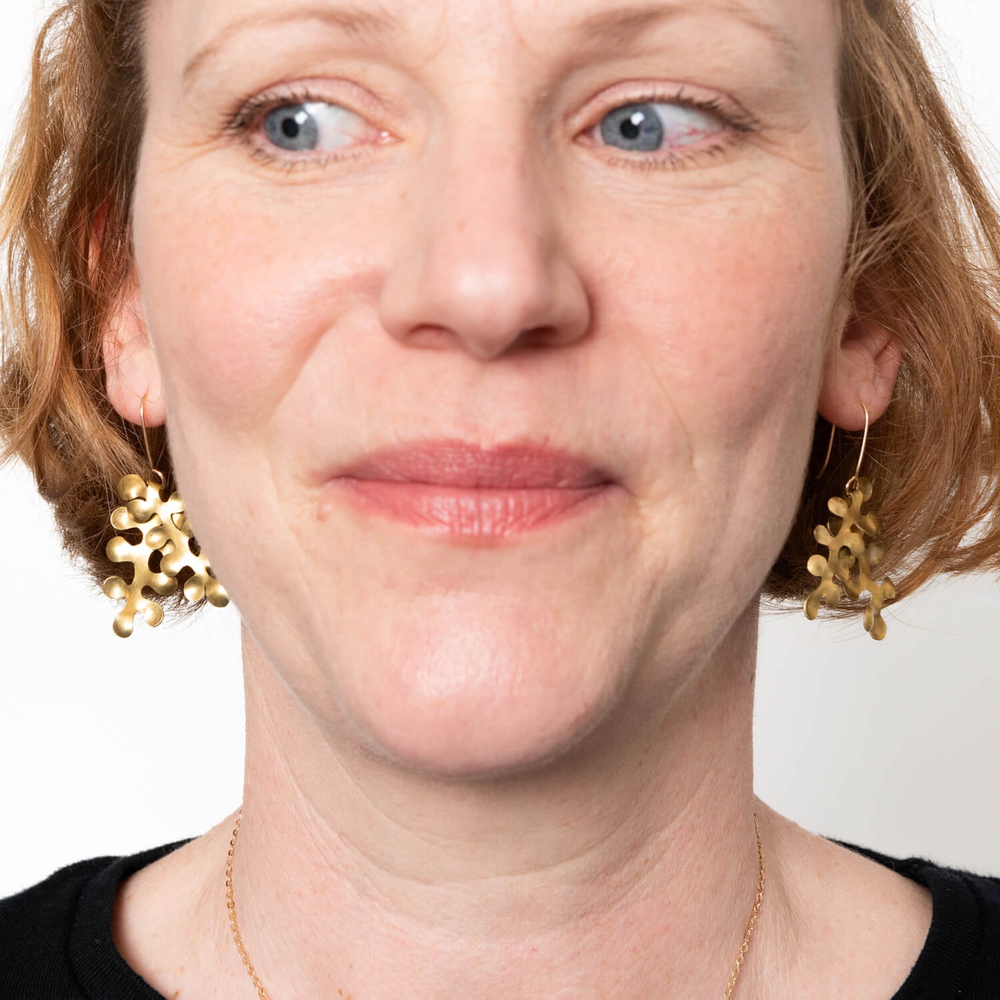 Model wearing brass seaweed bubble earrings