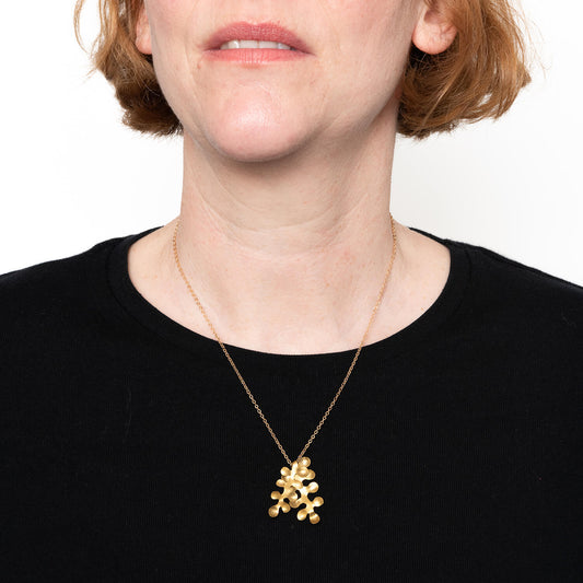 model wearing the brass bubble pendant