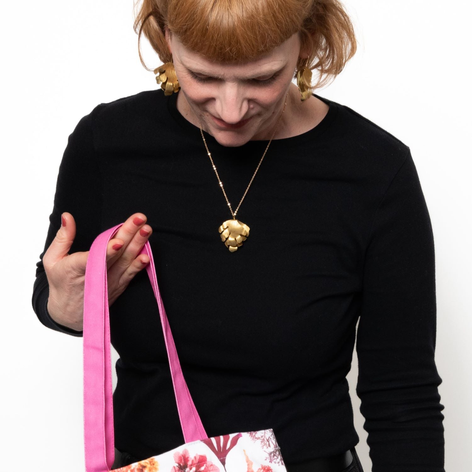 Shot of model wearing brass wave pendant