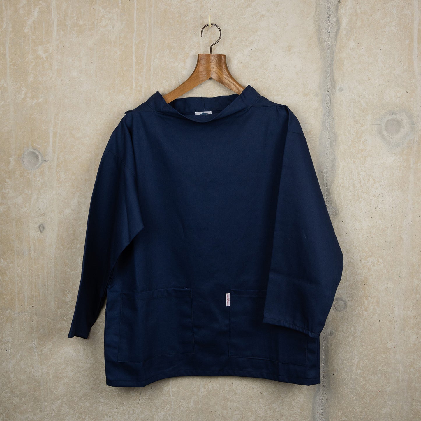 Navy blue cotton smock with front pockets and a crew neck
