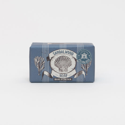 Packaged Cornish Sandalwood Soap on a white background. The packaging is dark blue with illustrations of a shell and seaweed.