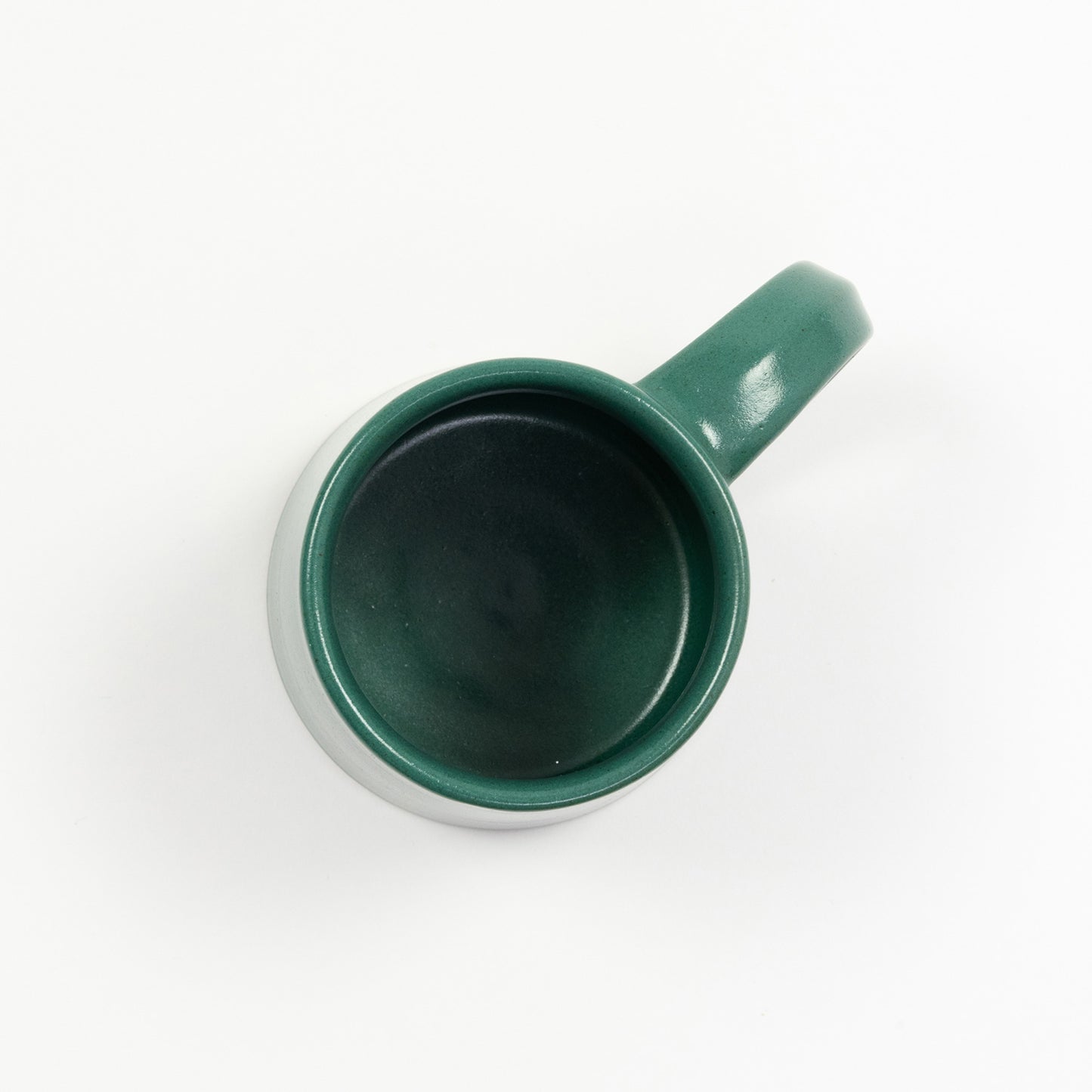 A teal coloured stoneware mug pictured on a white background.