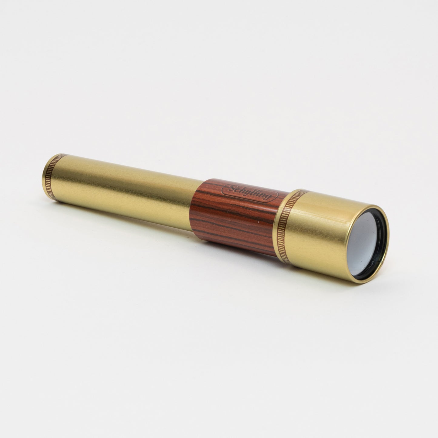 A tin toy telescope pictured on a white background.
