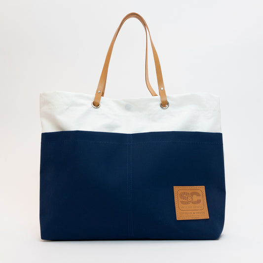 Recycled Sails Tote Bag, close up of leather patch to navy base. Stating Sails and Canvas, Topsham Devon.