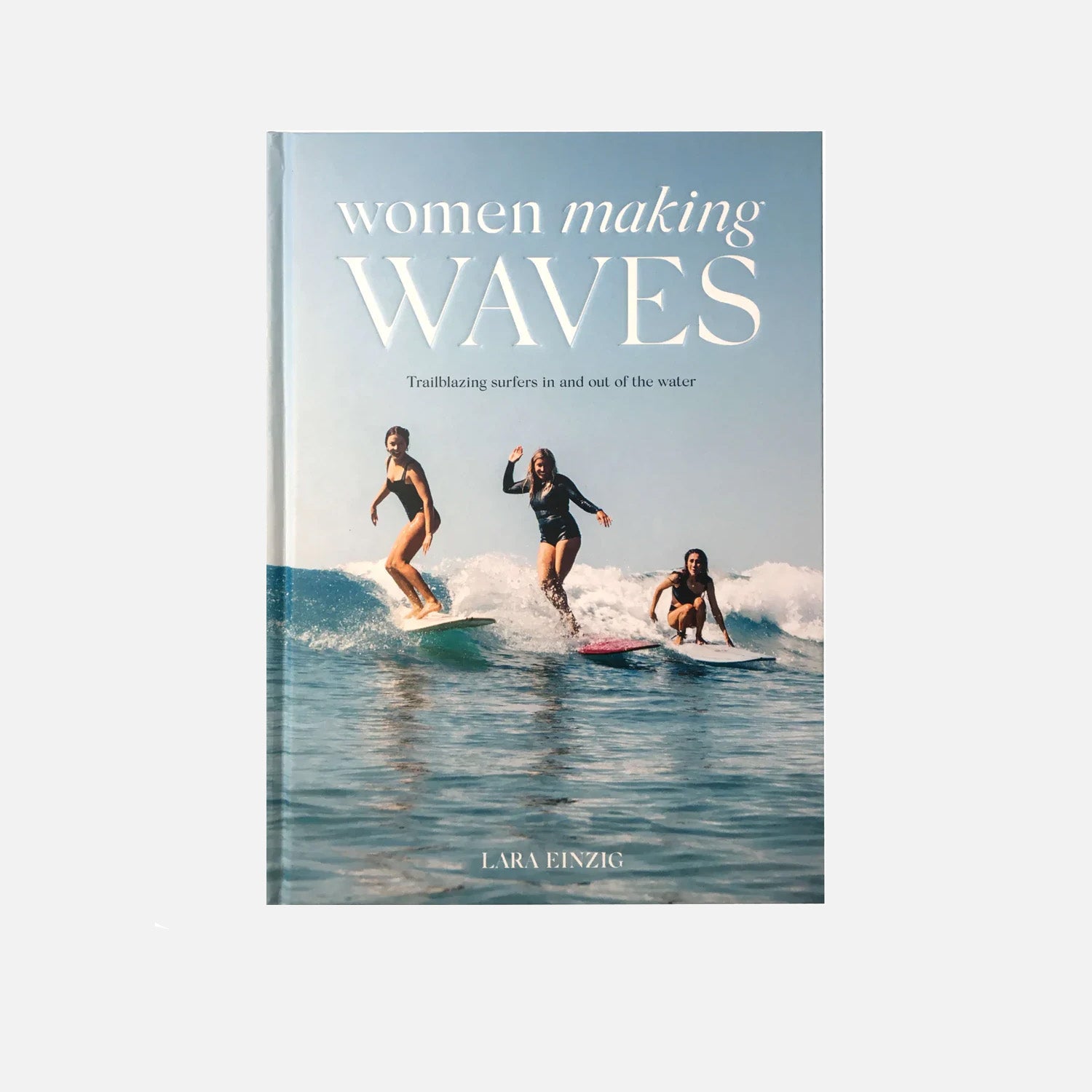 A book cover featuring three female surfers riding waves, showcasing empowerment in surfing with the title "Women Making Waves."