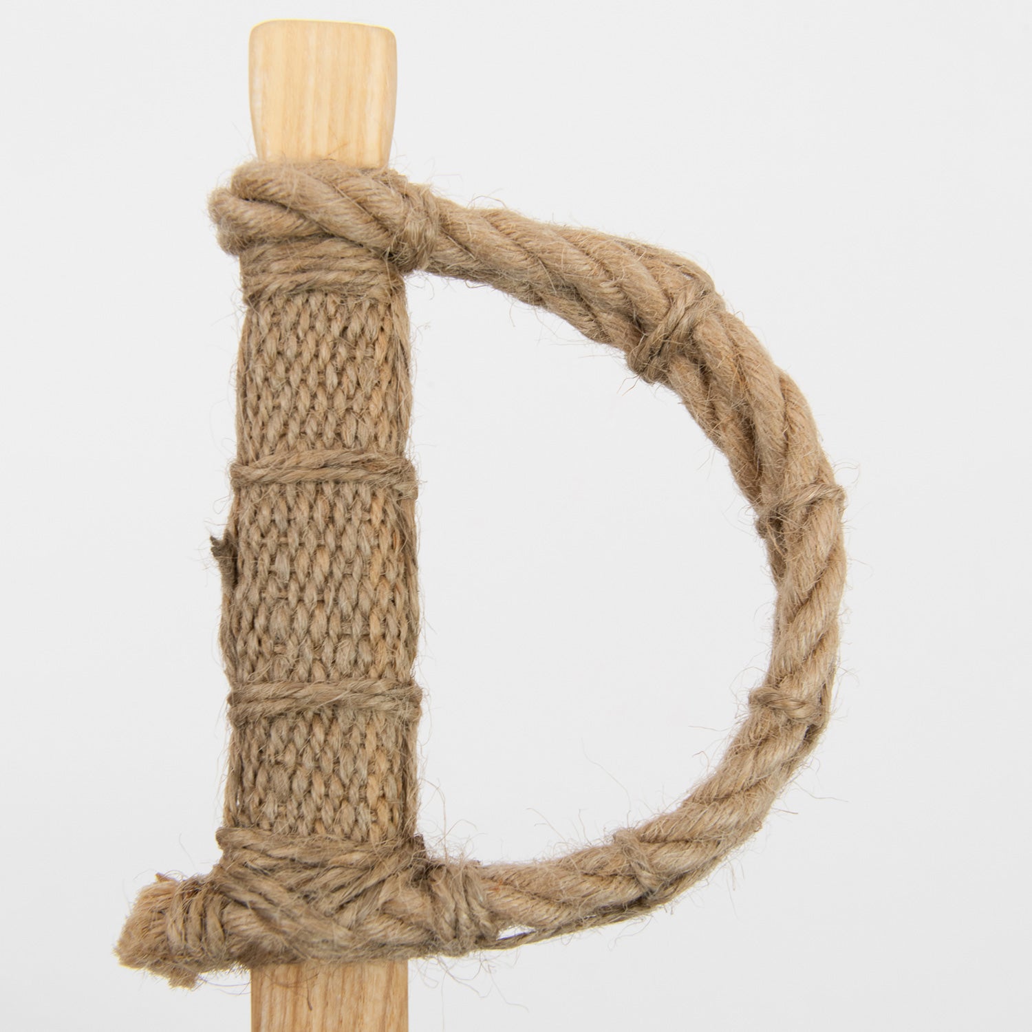 A wooden toy pirate sword pictured on a white background.
