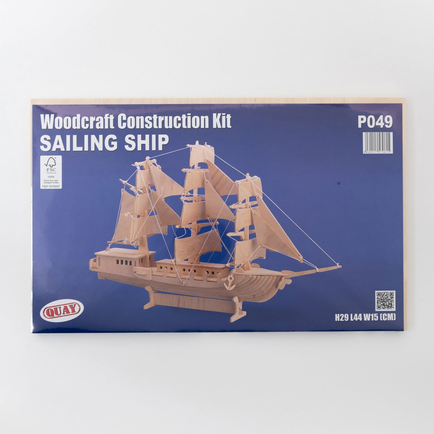 A wooden sailing ship construction kit. Pictured on a white background.