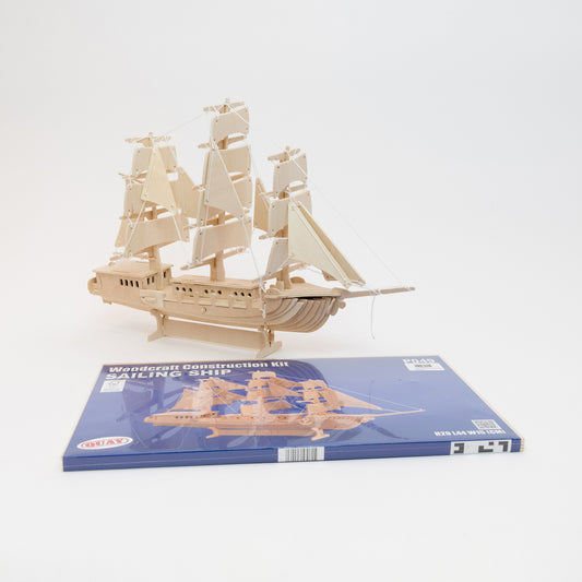 A wooden sailing ship construction kit. Pictured on a white background.