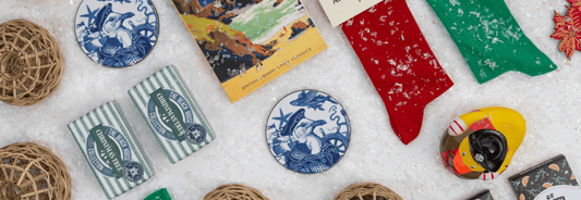 A collection of maritime gifts under £10 arranged on a table with snow flake decorations