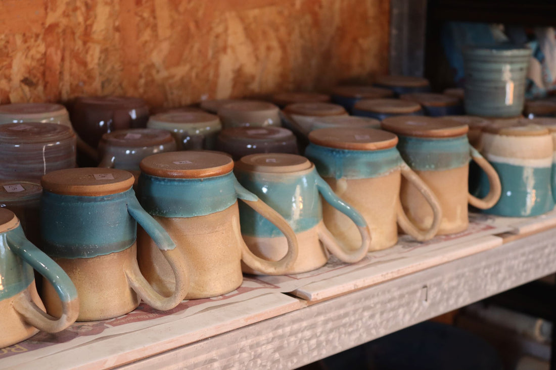 A collection of mugs on a shelf.