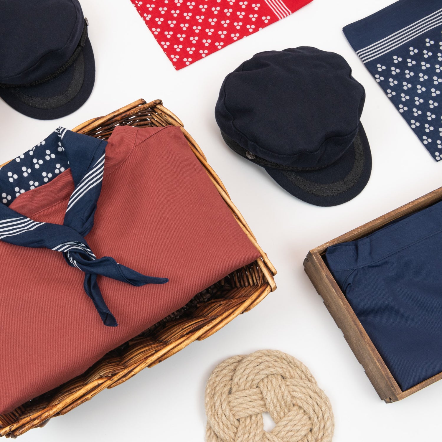 A photo of a selection of nautical-themed clothing and accessories pictured on a white table.