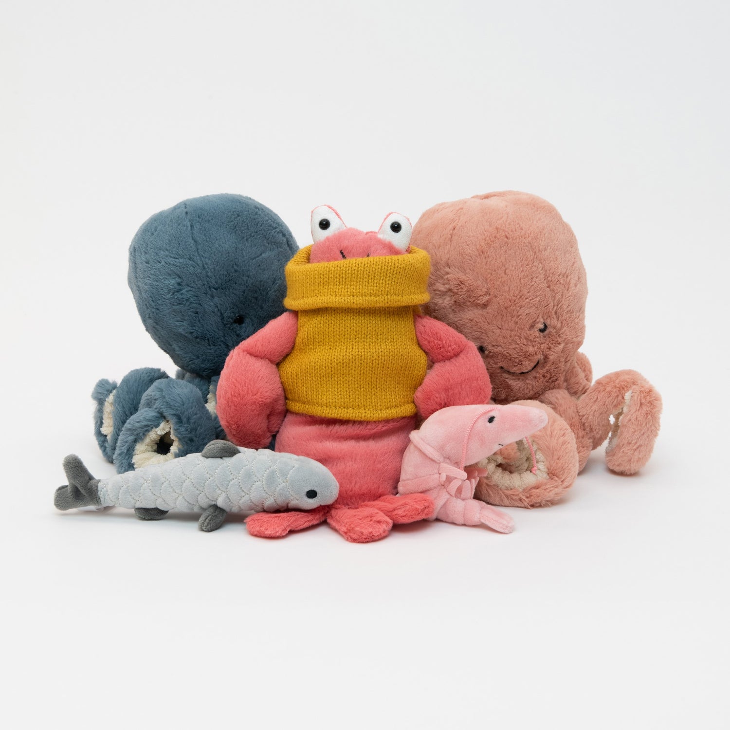 A collection of Jellycat plush soft toys pictured on a white background. There's a lobster, shrimp, sardine, and two octopuses. 