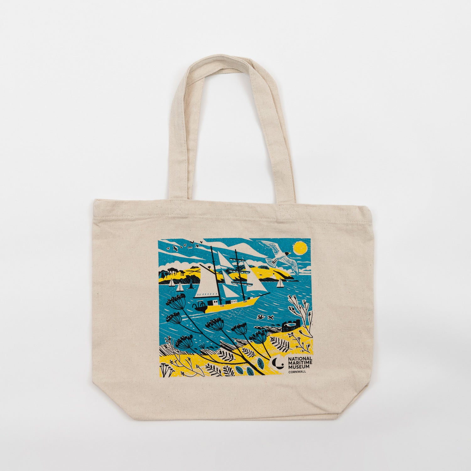 An off-white coloured tote bag featuring a blue and yellow Falmouth Tall Ships illustration on the front. Pictured on a white background.