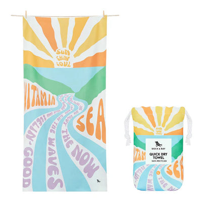 image showing vitamin sea design in pastel colours on the towel and the carry pouch it comes in 