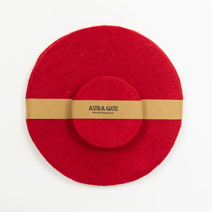 A set of red felt mats and red felt coasters. Pictured on a white background.