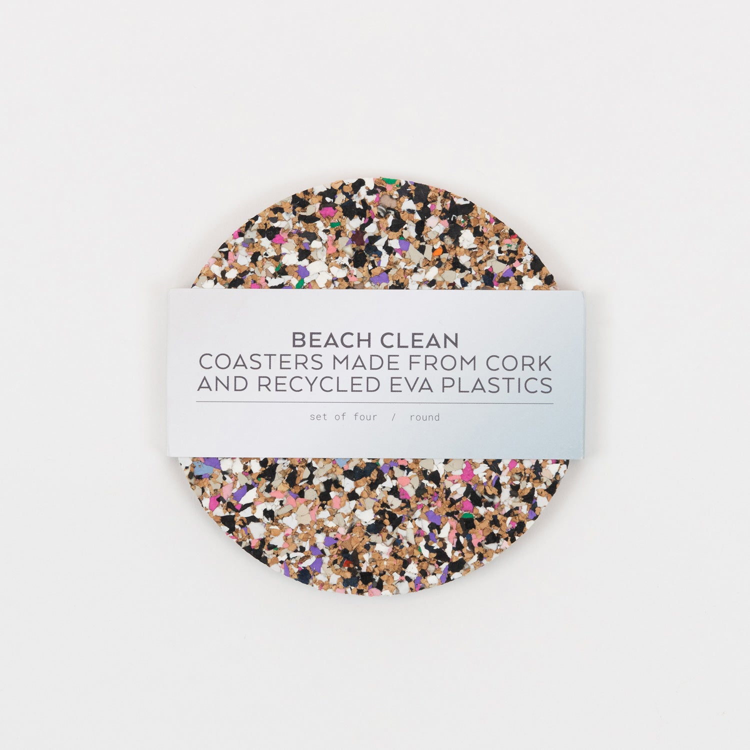 Top down view of the Beach Clean Coasters. The coasters are multi-coloured and the paper packaging goes around the coasters.