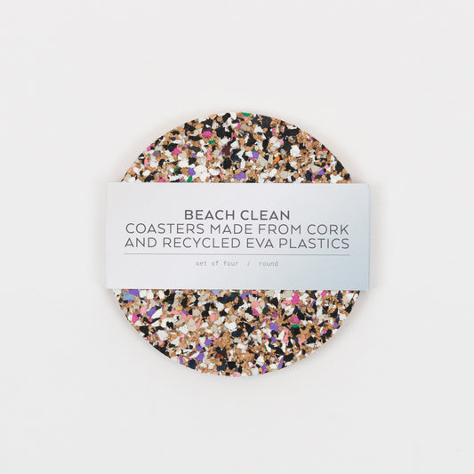 Top down view of the Beach Clean Coasters. The coasters are multi-coloured and the paper packaging goes around the coasters.